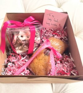 Chocolate covered pretzels with confettie sprinkles and seasonally flavored pumpkin bread topped